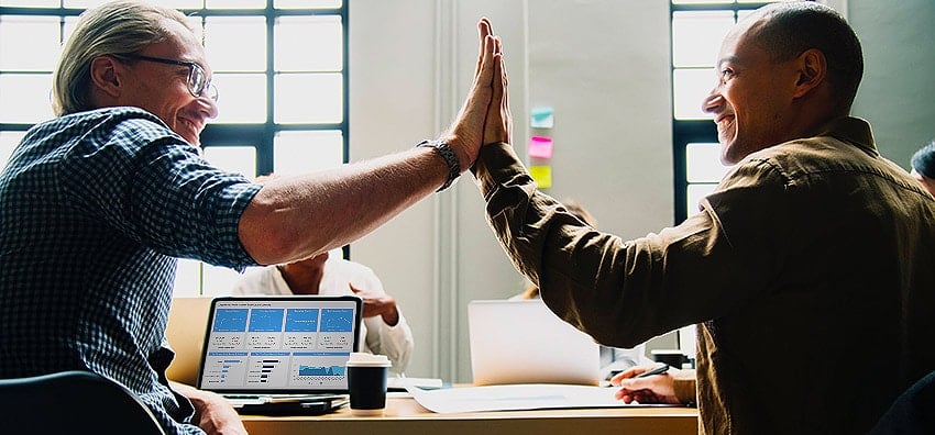 co-workers high-fiving each other