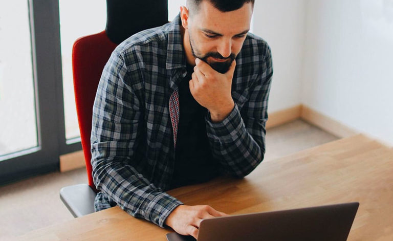 man with laptop thinking