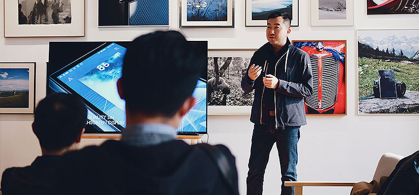 man presenting in front of crowd