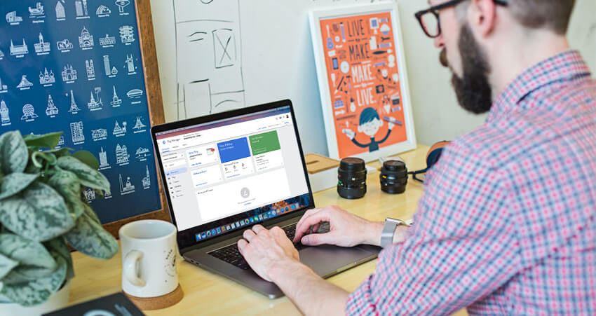 co-worker viewing google tag manager dashboard on laptop