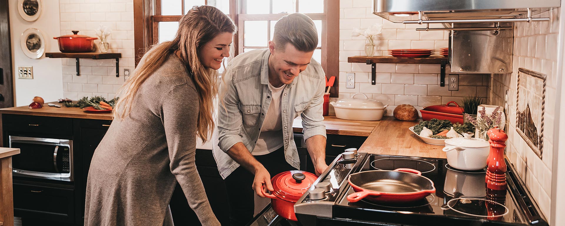 young couple using kitchen appliances