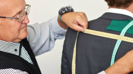 man tailoring a suit to demonstrate quality