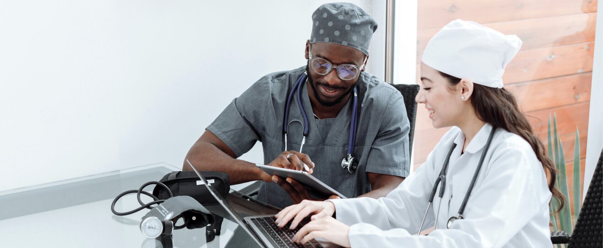 doctors discussing patient information displayed on tablet