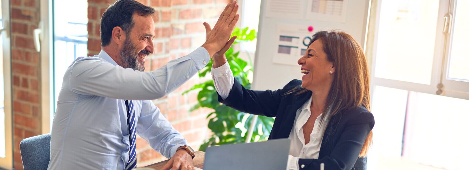 business professionals celebrating their immunity to the positivity bias