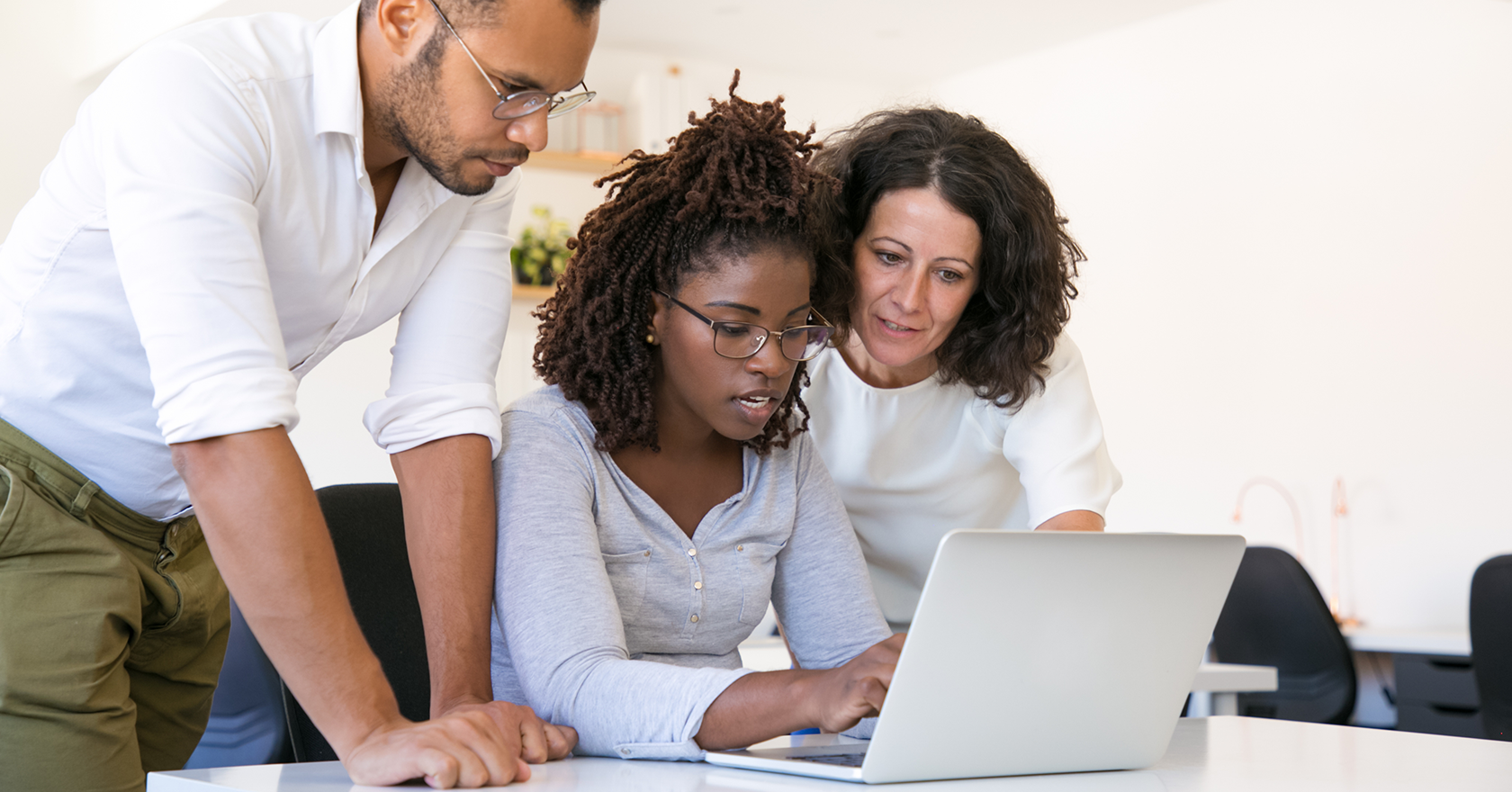 a young woman providing consulting expertise to male and female clients