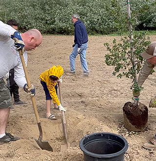 Andreia family planting trees for their community