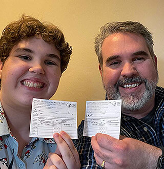 David Dobes family showing vaccination cards