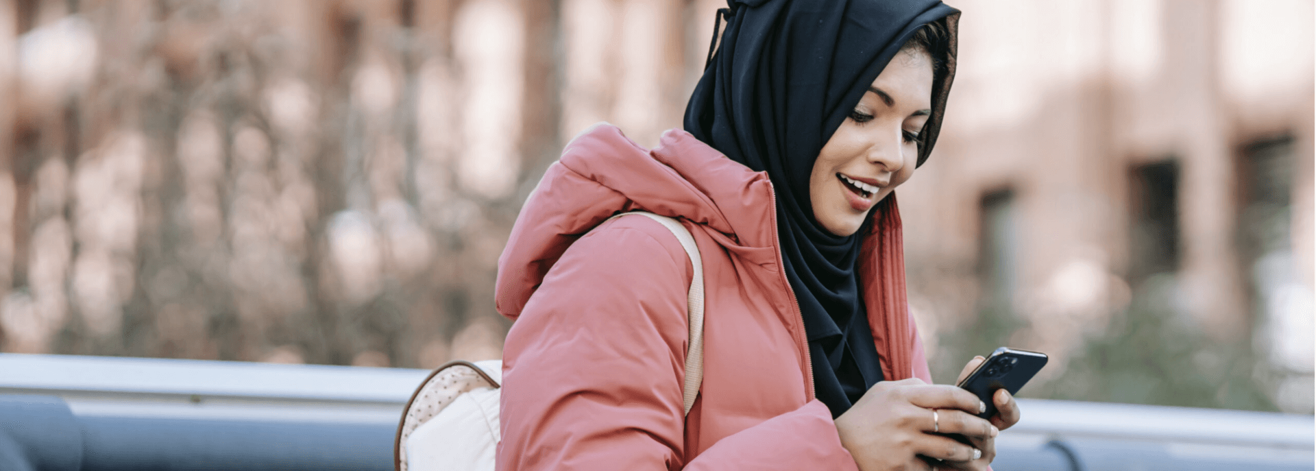 woman on park bench using phone 