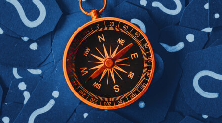 a compass surrounded by question marks - what's possible with customer journey optimization?