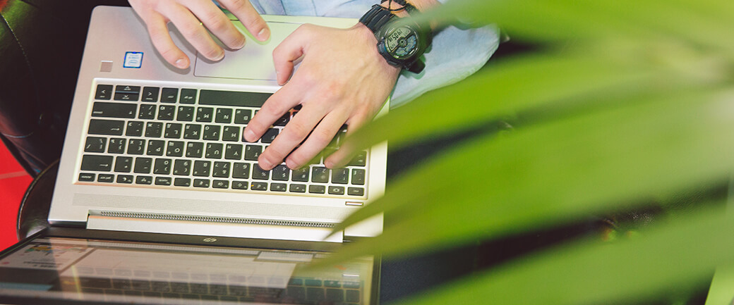 Hands typing on a laptop keyboard