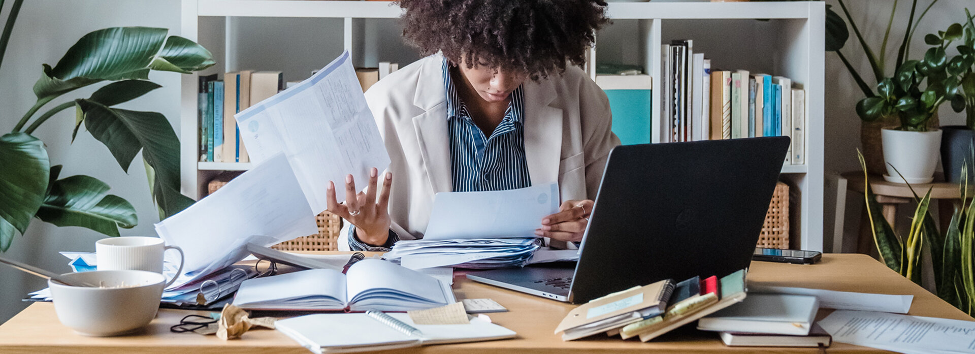 a woman at a cluttered desk