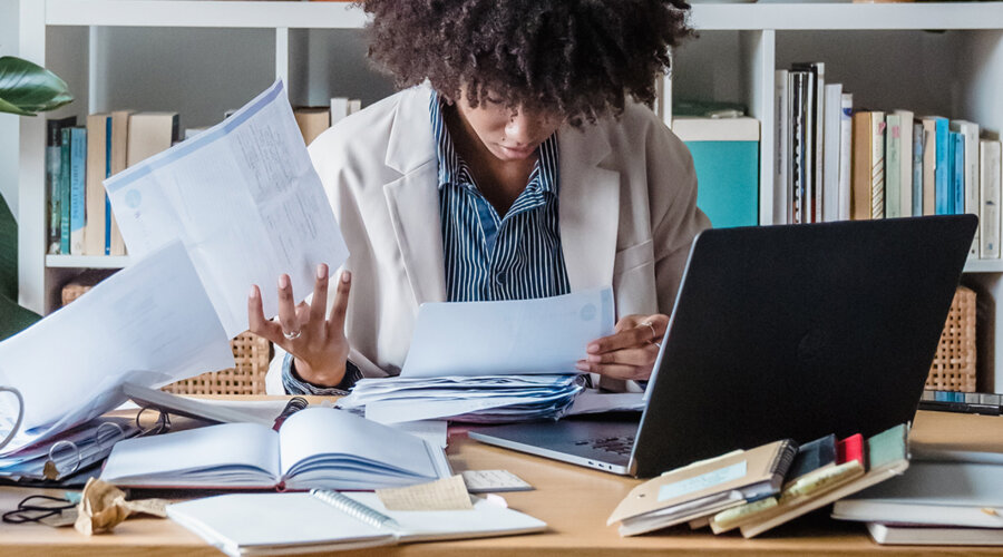 a woman at a cluttered desk