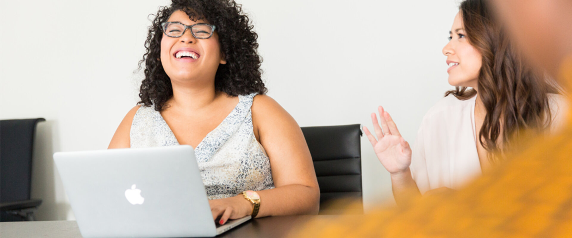 A woman laughs during a meeting