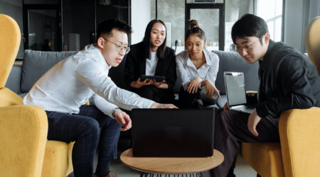 A group of people around a laptop