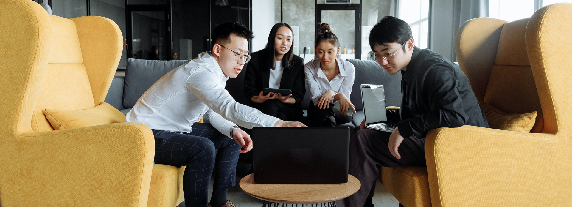 A group of people around a laptop