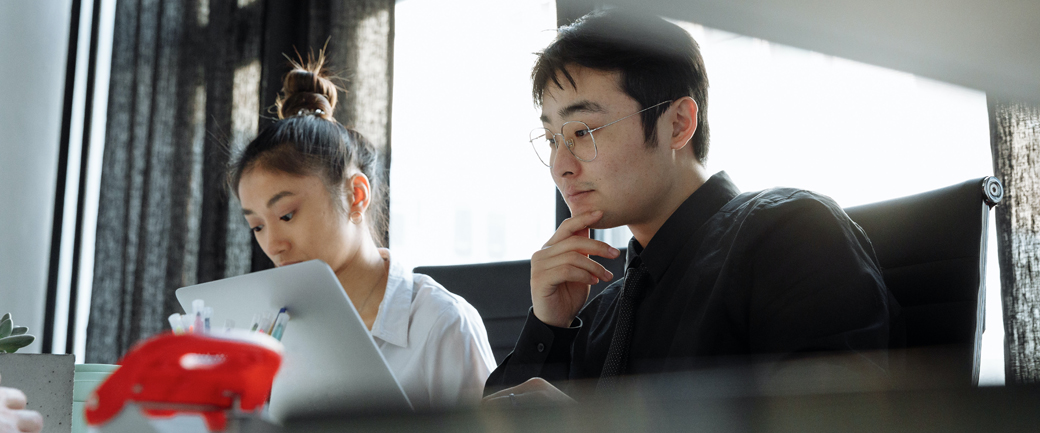 Two colleagues working at a desk