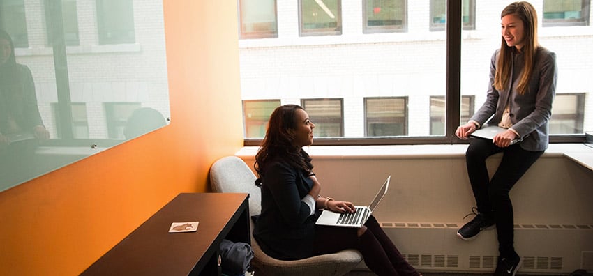 image of two women discussing adobe launch extensions